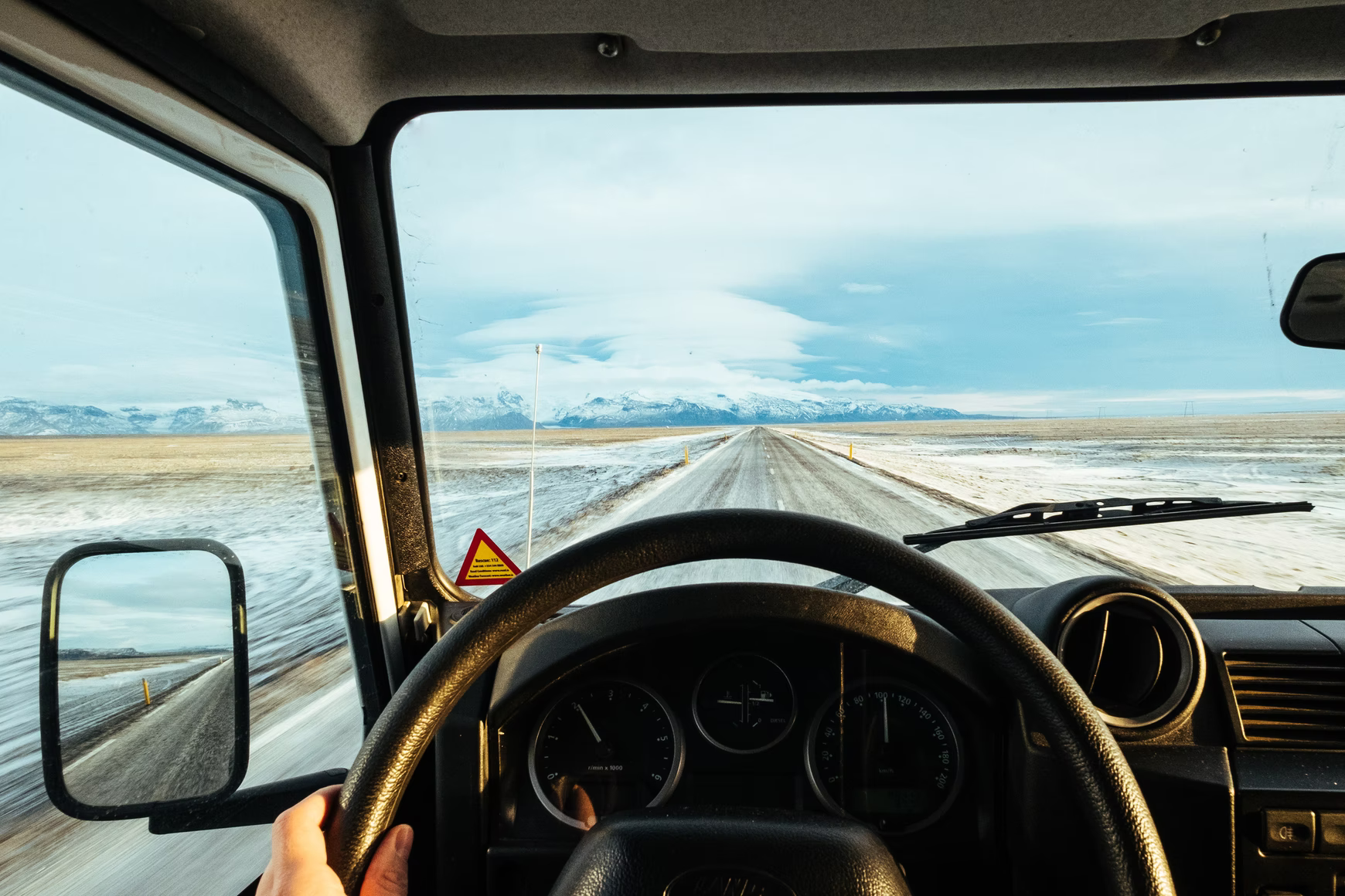 road trip in a car with open roads and mountains