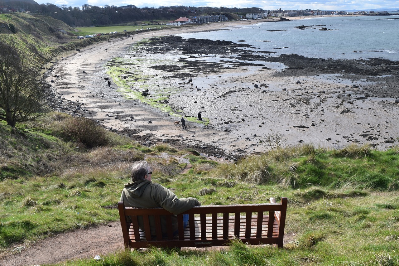 man sitting on beach in north berwick