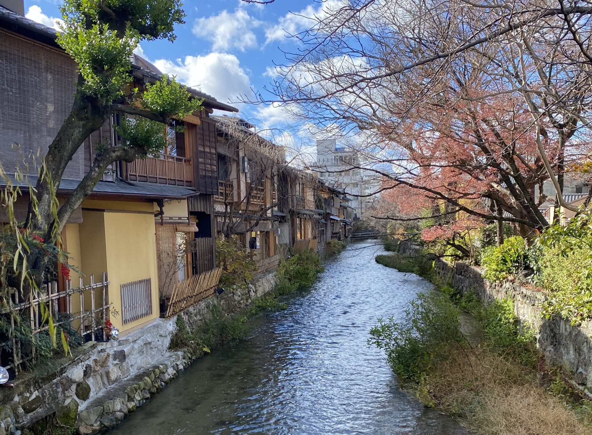 walkway along a river with traditional japanese archetecture