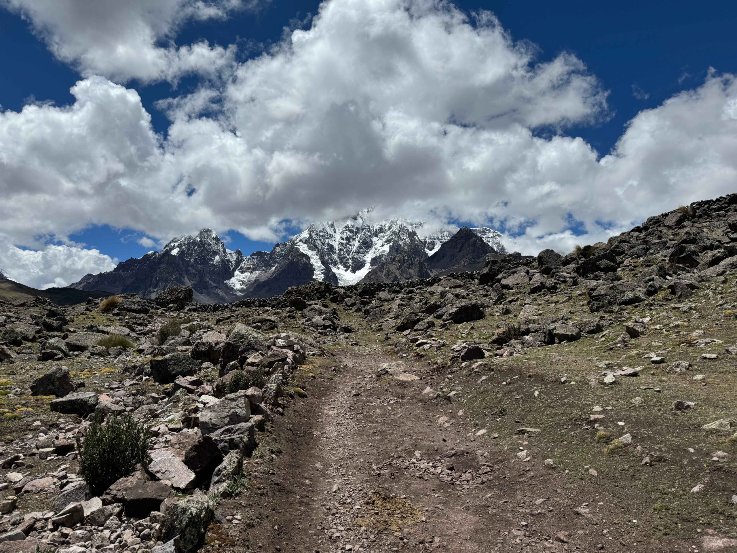 hiking trail at 7 lakes of ausangate with snow capped mountains in the distance