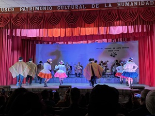 Stage performers wearing traditional Peruvian costumes