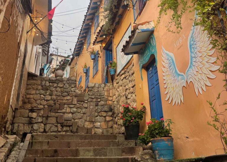 orange city street with street art and cobblestone stairs