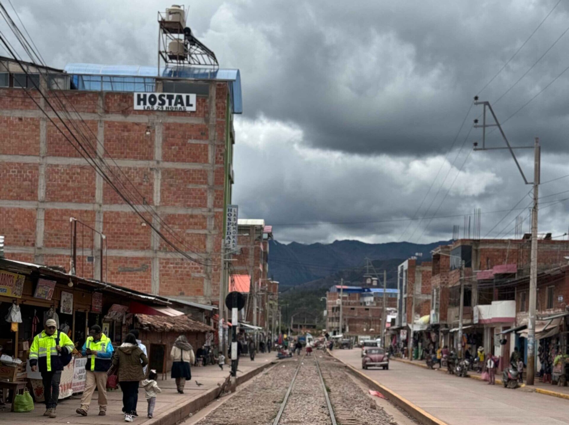 city street with railroad tracks in the center