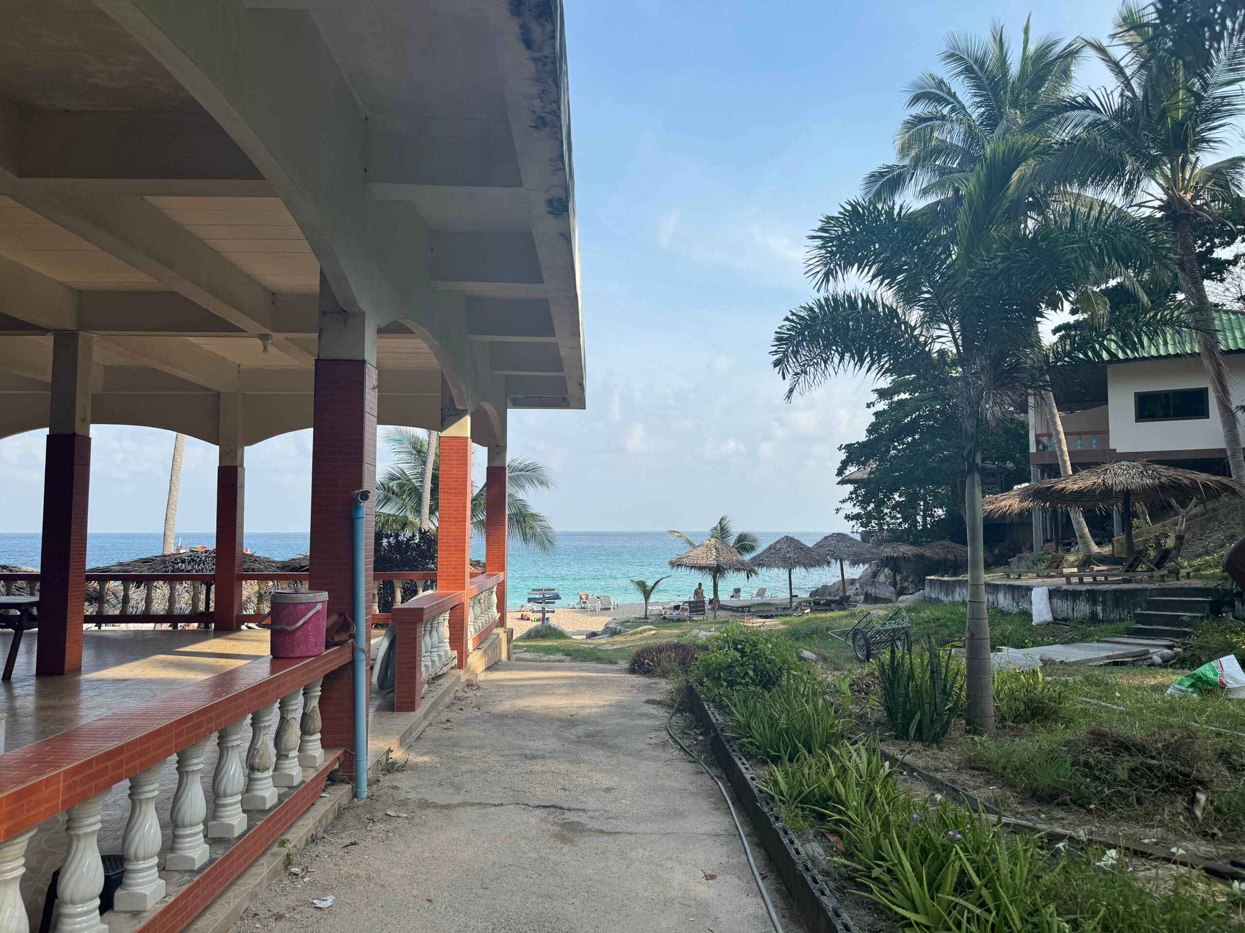 Aow Leuk Beach Entrance with sidewalk and blue ocean in the distance