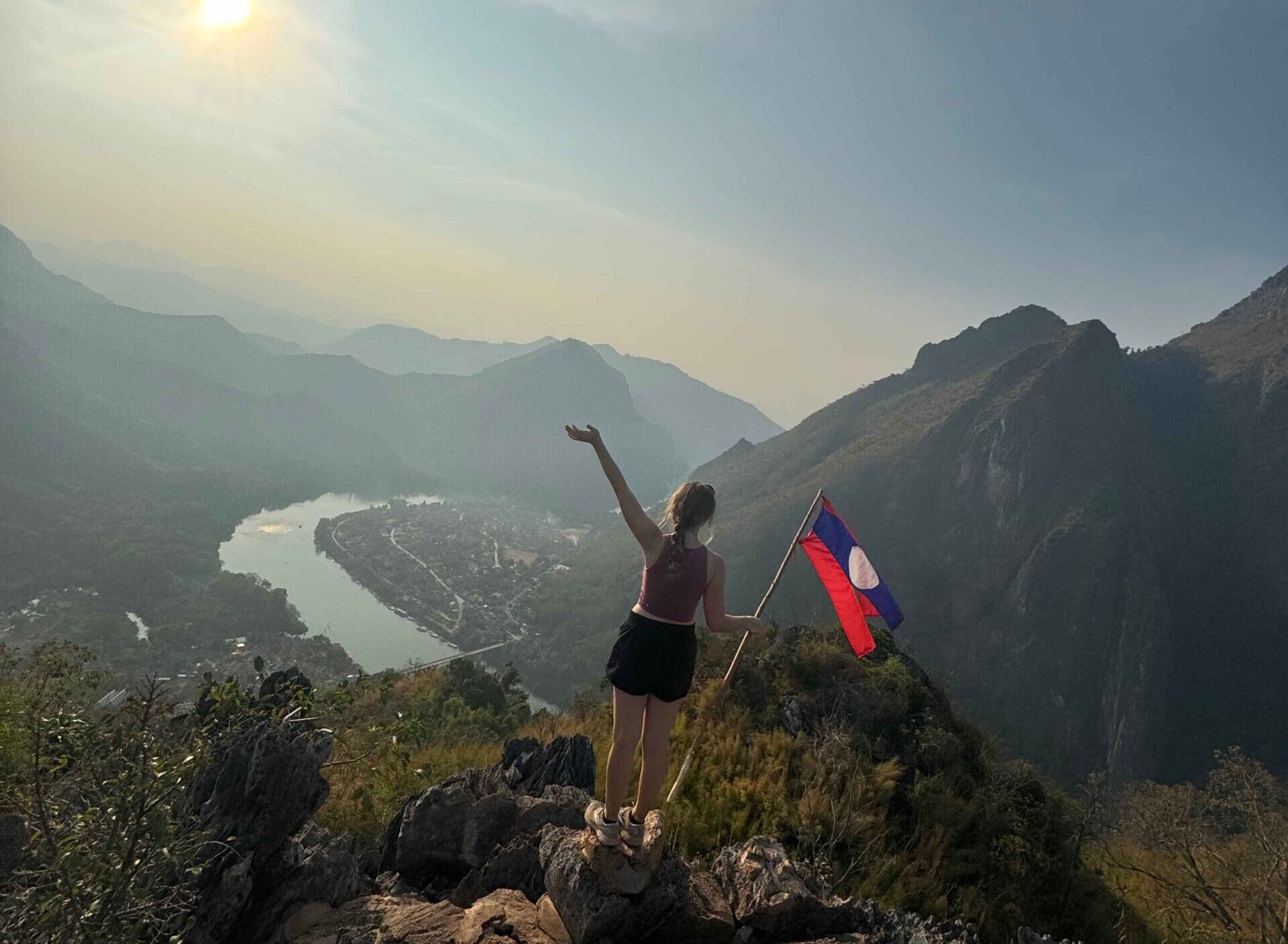 viewpoint with river, mountains, and Laos flag