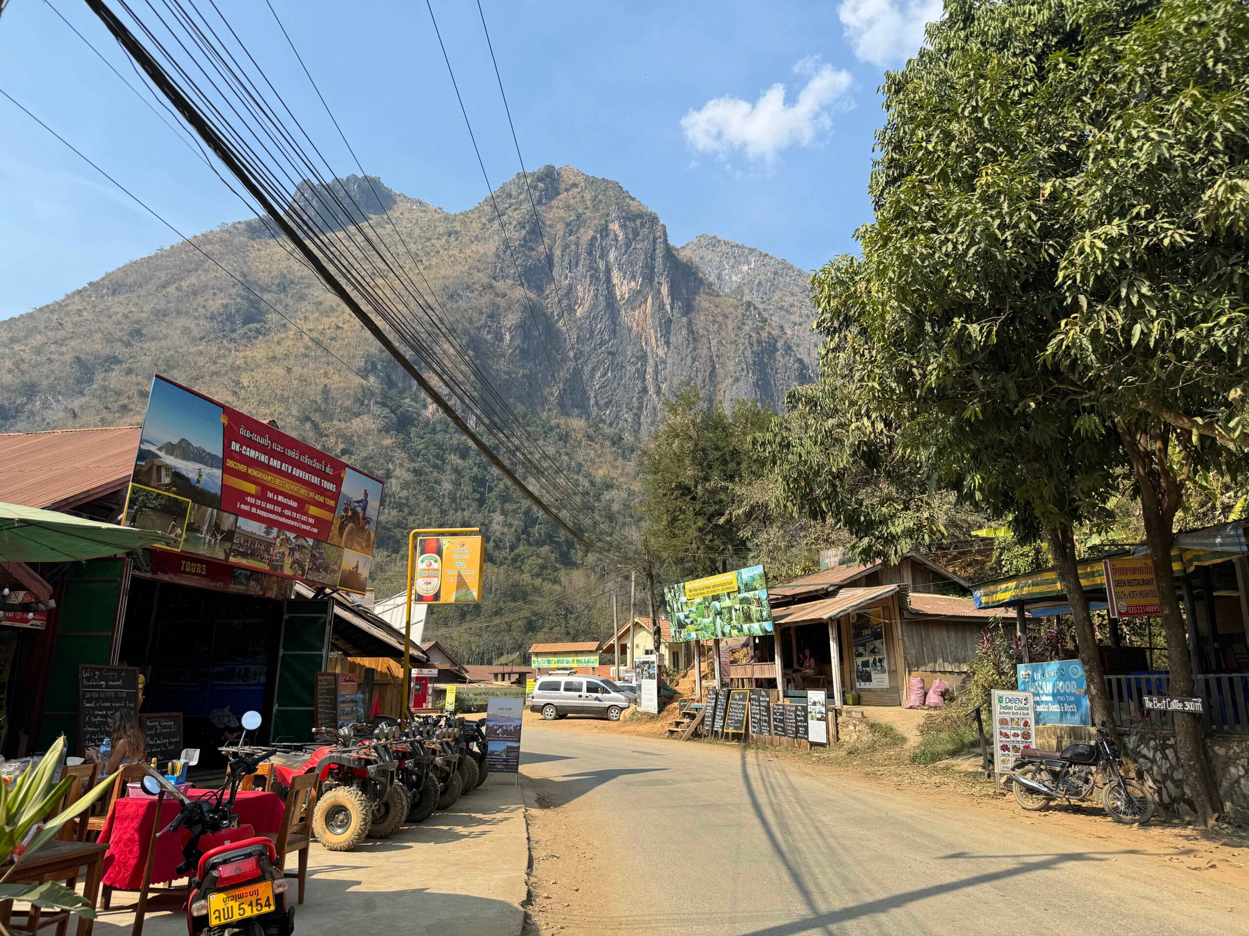 downtown nong khiaw road with small shops and a mountain - Nong Khaiw Viewpoints