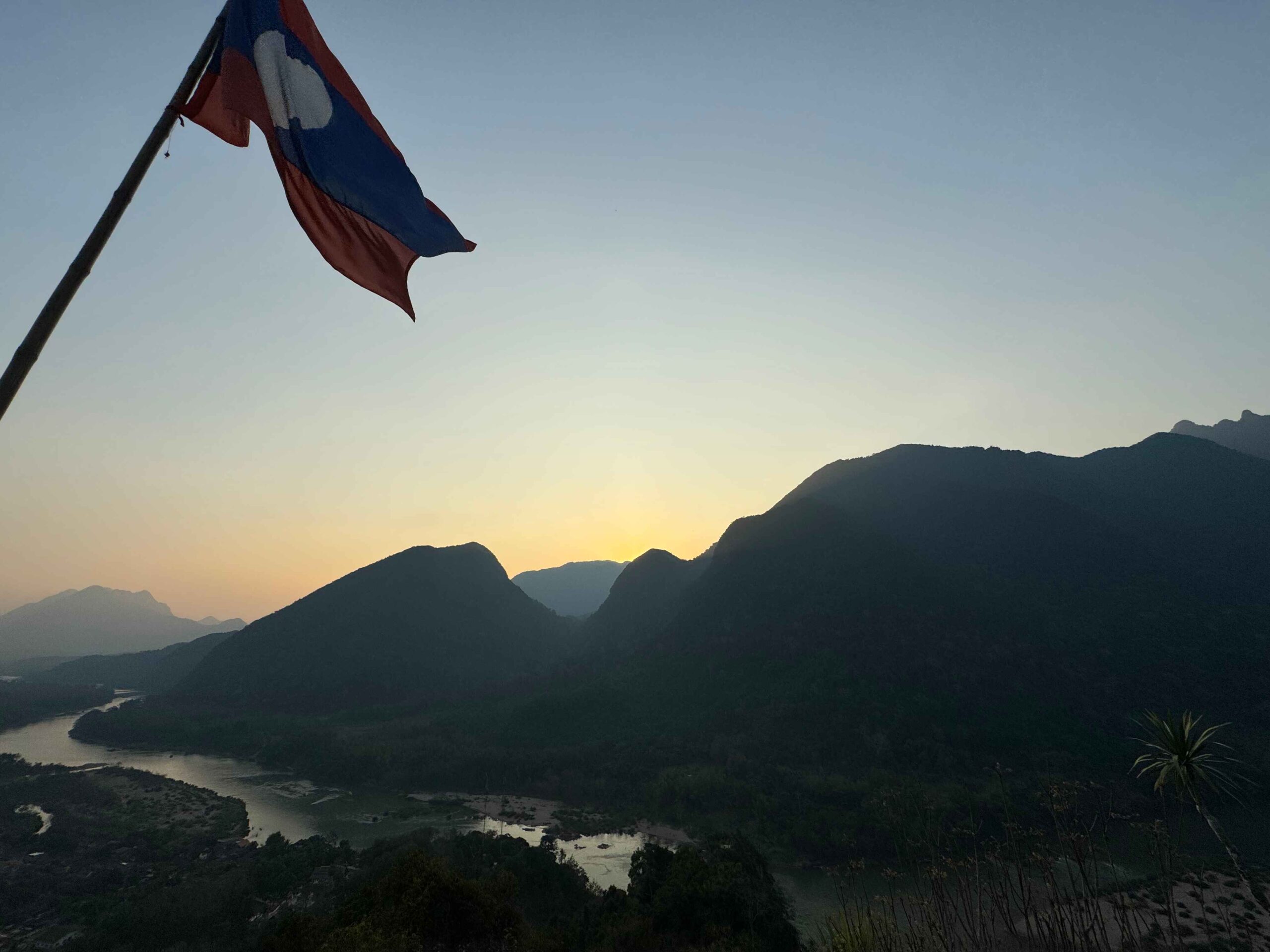 Phanoi Viewpoint - things to do in Muang Ngoy.. blue mountains while the sun is setting with a river at the bottom