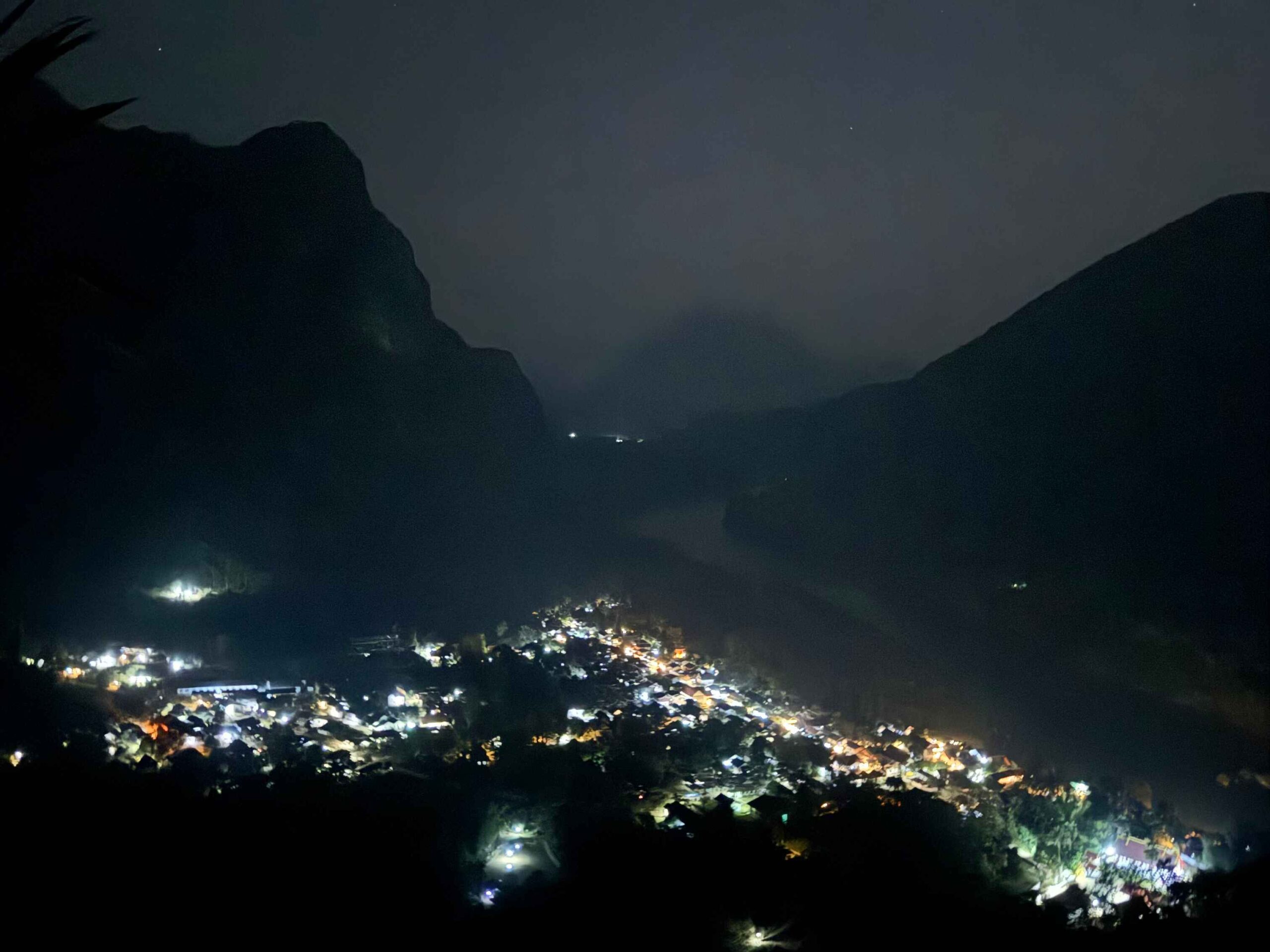 Phanoi Viewpoint in the dark with the city lights below and stars above